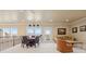 Bright living room with large windows, access to balcony, neutral tones and comfortable seating at 7615 Lemon Gulch Way, Castle Rock, CO 80108