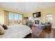 Serene main bedroom with a fireplace, sitting area, and large windows overlooking the landscape at 7615 Lemon Gulch Way, Castle Rock, CO 80108