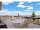 Spacious outdoor deck with ample seating and panoramic views of lake and landscape at 7615 Lemon Gulch Way, Castle Rock, CO 80108