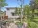 Charming home backyard featuring lush landscaping, mature trees, and a serene pond at 13244 Kearney St, Thornton, CO 80602
