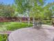Expansive backyard featuring a stone patio, mature trees, and lush green lawn at 13244 Kearney St, Thornton, CO 80602