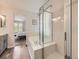 Bright bathroom features a separate shower, a soaking tub, and access to the bedroom at 13244 Kearney St, Thornton, CO 80602
