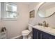 Charming powder room features stylish vanity, round mirror, and decorative accents at 13244 Kearney St, Thornton, CO 80602