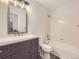 Nicely updated bathroom with modern vanity, updated mirror, and shower-tub combination at 13244 Kearney St, Thornton, CO 80602