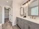 Beautiful bathroom with dual sinks, modern vanity, and stylish wood-look flooring at 13244 Kearney St, Thornton, CO 80602