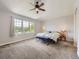 Spacious bedroom with plush carpeting, large windows, and a comfortable seating area at 13244 Kearney St, Thornton, CO 80602