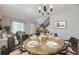 Spacious dining room featuring an elegant table setting and modern chandelier lighting at 13244 Kearney St, Thornton, CO 80602