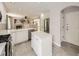 Open kitchen with stainless steel appliances, quartz countertops, center island, and hardwood flooring at 13244 Kearney St, Thornton, CO 80602