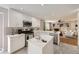 Bright kitchen with white cabinets, stainless steel appliances, and a view of the living room at 13244 Kearney St, Thornton, CO 80602