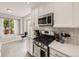 Bright kitchen features stainless steel appliances, a gas range, and white cabinets, perfect for modern living at 13244 Kearney St, Thornton, CO 80602
