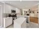 Modern kitchen featuring white cabinets, stainless steel appliances, quartz countertops, and a tiled backsplash at 13244 Kearney St, Thornton, CO 80602
