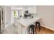 Modern kitchen with stainless steel appliances, breakfast bar, and adjacent dining area at 13244 Kearney St, Thornton, CO 80602