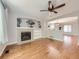 Cozy living room with a fireplace, ceiling fan, hardwood floors, and an arched entryway at 13244 Kearney St, Thornton, CO 80602
