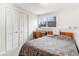 Cozy bedroom features a window letting in natural light and a closet for storage at 2145 S Lewiston St, Aurora, CO 80013
