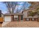Charming home featuring a brick facade, gray siding, a well-kept lawn, and a single-car garage at 2145 S Lewiston St, Aurora, CO 80013