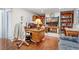 Comfortable home office space with hardwood floors, built-in shelving, and a brick fireplace at 2145 S Lewiston St, Aurora, CO 80013