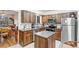 Bright kitchen featuring wood cabinets, stainless steel appliances, granite countertops, and an island at 2145 S Lewiston St, Aurora, CO 80013