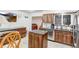 Well-lit kitchen featuring wood cabinetry, granite countertops, a stainless steel dishwasher, and a functional island at 2145 S Lewiston St, Aurora, CO 80013