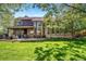 Large backyard featuring mature landscaping, spacious patio, and large windows offering plenty of light at 5753 S Kittredge St, Centennial, CO 80015