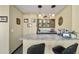 Stylish bar area boasts granite countertops, custom cabinetry, and unique pendant lighting at 5753 S Kittredge St, Centennial, CO 80015