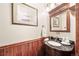 Charming powder room with dark wood paneling and a decorative granite sink at 5753 S Kittredge St, Centennial, CO 80015