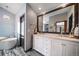 Modern bathroom featuring a soaking tub, walk-in shower, dual sinks, and lots of vanity space at 5753 S Kittredge St, Centennial, CO 80015