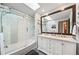 Bathroom showcasing a double vanity, large framed mirror, walk-in glass shower, and tub at 5753 S Kittredge St, Centennial, CO 80015