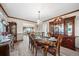 Dining room featuring hardwood floors, an elegant chandelier, and a classic wood china cabinet at 5753 S Kittredge St, Centennial, CO 80015