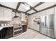 Bright kitchen featuring stainless steel appliances, plenty of cabinet space, and hardwood floors at 5753 S Kittredge St, Centennial, CO 80015