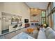 Open-concept living room with a brick fireplace, bar area, and comfortable seating arrangement at 5753 S Kittredge St, Centennial, CO 80015
