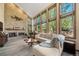 Bright living room featuring a brick fireplace, large windows, and modern sectional sofa at 5753 S Kittredge St, Centennial, CO 80015