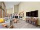 Open-concept living room with modern furniture, a large television, and beautiful natural light at 5753 S Kittredge St, Centennial, CO 80015