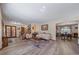 Open-concept living room with hardwood floors and seamless access to the dining area at 5753 S Kittredge St, Centennial, CO 80015