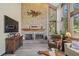 Comfortable living room featuring a brick fireplace, entertainment center, and large windows at 5753 S Kittredge St, Centennial, CO 80015