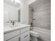 Contemporary bathroom featuring sleek white cabinets, quartz countertops, and stylish tiled shower and tub at 779 Kohlor Dr, Lafayette, CO 80026