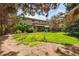 Large backyard with mature trees, green lawn, and patio area, offering a private outdoor oasis at 6219 S Krameria St, Centennial, CO 80111