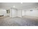 Spacious carpeted basement area with a neutral color palette and good lighting, with an adjacent stairwell at 6219 S Krameria St, Centennial, CO 80111