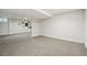 Spacious carpeted basement area with a neutral color palette and good lighting, adjacent to a decorated wall at 6219 S Krameria St, Centennial, CO 80111