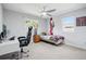 Neutral bedroom with a ceiling fan, a desk and a bed with a colourful throw, and large picture on the wall at 6219 S Krameria St, Centennial, CO 80111