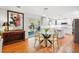 Open dining area with hardwood floors, glass table, and sliding doors to the backyard at 6219 S Krameria St, Centennial, CO 80111