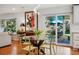 Dining area featuring hardwood floors, backyard views, and access to the outdoor patio at 6219 S Krameria St, Centennial, CO 80111