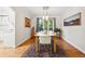 Bright dining room with hardwood floors, a modern light fixture, and large windows overlooking the garden at 6219 S Krameria St, Centennial, CO 80111