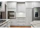 Contemporary kitchen featuring stainless steel appliances, white cabinets, and elegant granite countertops at 6219 S Krameria St, Centennial, CO 80111
