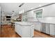 Open kitchen layout featuring modern appliances, an island, and seamless flow into the adjacent living spaces at 6219 S Krameria St, Centennial, CO 80111