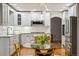 Bright kitchen boasts white cabinetry, stainless appliances, stone countertops, and a dining area at 6219 S Krameria St, Centennial, CO 80111