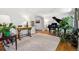 Open-concept living area featuring hardwood floors, a classic piano, and stylish furnishings and decor at 6219 S Krameria St, Centennial, CO 80111