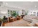 Open living room with a bay window, comfortable seating, and a view into the kitchen at 6219 S Krameria St, Centennial, CO 80111