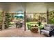 Covered patio with a dining set, log storage, outdoor chairs and views of a lush green yard, plus an umbrella at 6219 S Krameria St, Centennial, CO 80111