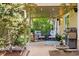 Covered patio with comfortable seating, a fountain, lush greenery and beautiful potted plants on the side at 6219 S Krameria St, Centennial, CO 80111
