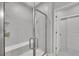 Modern walk-in shower featuring a glass door and a built-in shower bench at 6211 W 28Th Ct, Wheat Ridge, CO 80214
